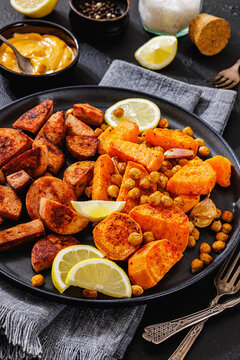 roasted sliced sausage with sweet potato on plate