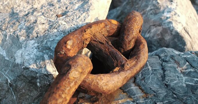 Extreme close up of orange rust on thick metal chain links