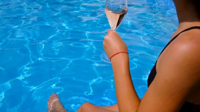 Champagne by the pool. Selective focus.