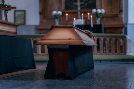 Wooden Coffin Draped in Black Cloth Inside Church Before Funeral Service