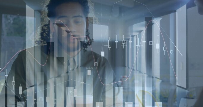 Analyzing colleagues in business attire reviewing financial charts at office with laptop