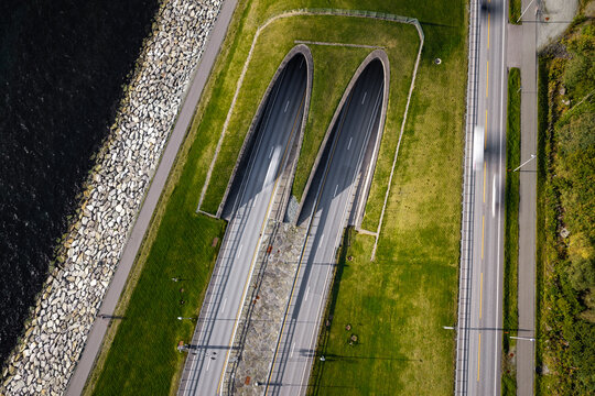 Aerial view of the Ryfast Tunnel entrance with dual lanes, adjacent road, and rocky shoreline in Solbakk, Rogaland, Norway.