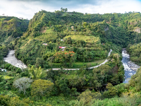 Aerial view of Estrecho del Rio Magdalena with lush green hills, winding river, and dense vegetation in San Agustin, Huila, Colombia.