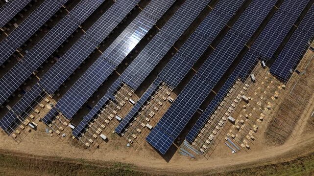 Close up aerial view of photovoltaic solar panels and metal mounting frames under construction on a rural site in England, UK