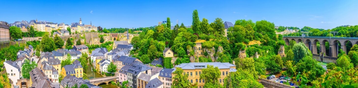 Luxembourg panorama, aerial panoramic view Luxembourg City centre, Luxembourg old town Grund and Ville Haute in Alzette river valley with Bock rocks, old colorful buildings, Pulvermuhl stone viaduct