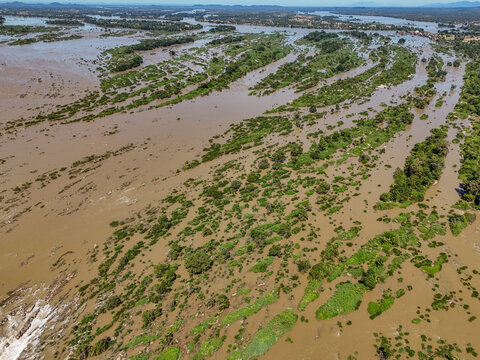Aerial view of the Mekong River at Don Khon, featuring small islands, lush vegetation, and flowing brown water in the Si Phan Don archipelago, Khong, Champasak Province, Laos.