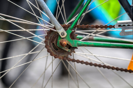 Rusty bicycle chain and rear sprocket close up.