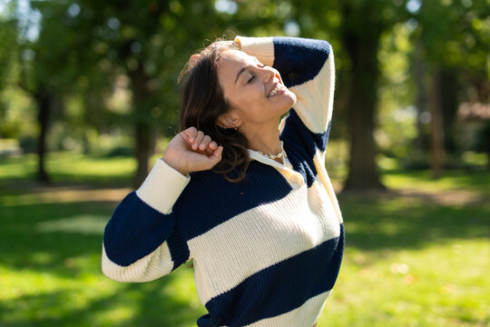 Woman stretching outdoors feeling happy and relaxed