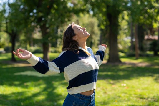 Woman enjoying freedom and happiness outdoors in park