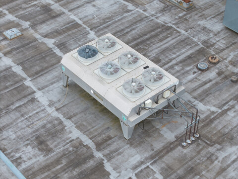 Melbourne, VIC, Australia - 14 October 2026: Aerial view of Bayswater North Factories, showing an industrial HVAC cooling unit with multiple fans installed on a flat rooftop.