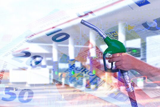 Hand holding fuel pump nozzle with euro banknotes and financial chart overlay at gas station. Fuel price increase, petrol cost or energy market concept.
