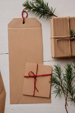 Blank kraft envelopes and small parcel with red twine