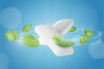 Menthol chewing gum pieces and mint leaves in air against blue background © New Africa