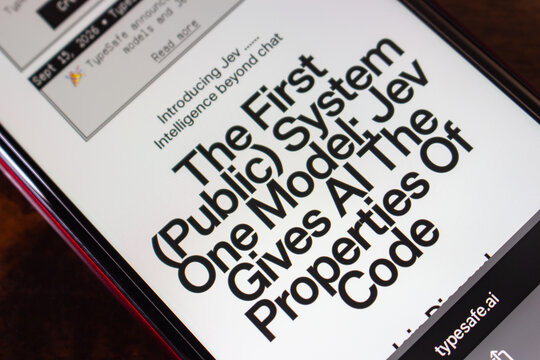 Quetzaltenango, GUATEMALA - Oct 2 2026 : Smartphone showing the typesafe.ai page introducing Jev, headlined as the first public System One model giving AI the properties of code.
