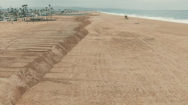 Aerial view of tall sand berms built along Newport Beach to protect shoreline from storm waves.