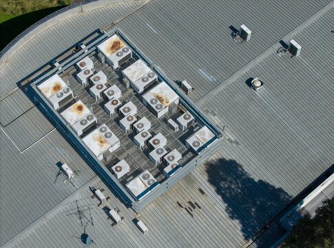 Melbourne, Victoria, Australia - 08 October 2026: Aerial view of a data centre roof featuring multiple HVAC units arranged in rows on a corrugated metal surface.