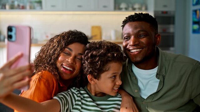 Family taking selfie pink phone home. Parents son posing smiling living room.