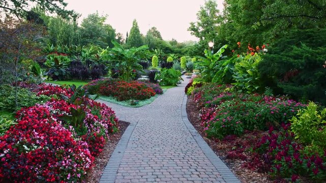 Vibrant botanical garden path leading past colorful coleus and ornate dome gazebo at Sunken Gardens in Lincoln Lancaster County Nebraska