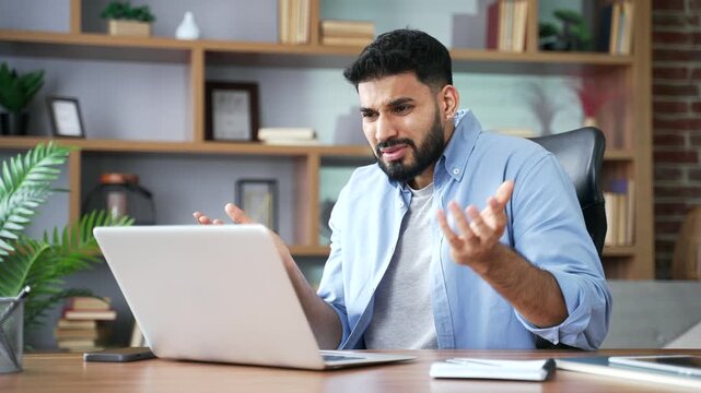 A frustrated confused man uses a laptop at a desk in a home office. He struggles with a failed online transaction, frowns at a declined payment screen, and feels stressed by a digital error.