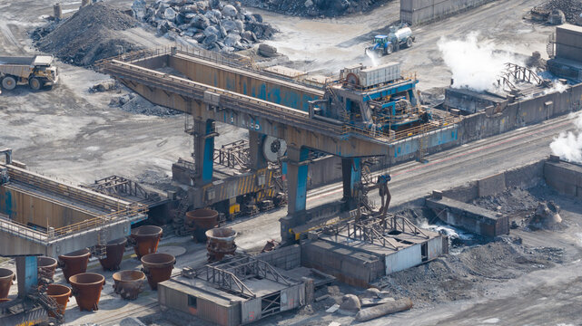 Velsen-Noord, Netherlands - 05 May 2026: Aerial view of Tata Steel industrial site featuring a large gantry crane, molten metal ladles, and heavy machinery operating within the steelworks facility.