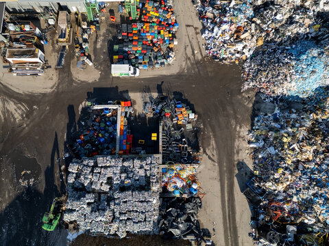 Kempele, North Ostrobothnia, Finland - 08 October 2026: Aerial view of the waste management centre with piles of sorted recyclables, plastic containers, and industrial machinery.