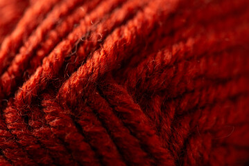 Close-up of red wool yarn texture for knitting and cozy craft projects © ActionGP