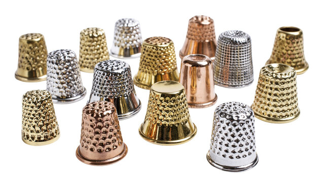 Isolated shiny metal thimbles group for sewing and crafting. Gold, silver, bronze finger protectors.