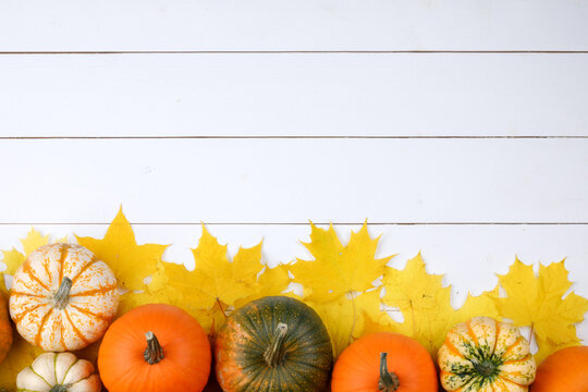 Flat lay arrangement with pumpkins on wooden background