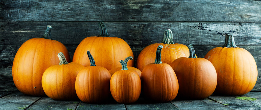 Flat lay arrangement with pumpkins on wooden background