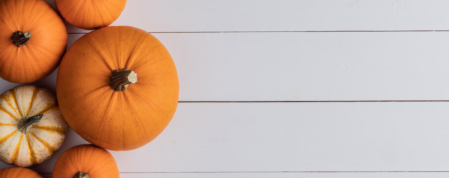 Flat lay arrangement with pumpkins on wooden background