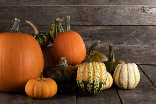 Flat lay arrangement with pumpkins on wooden background