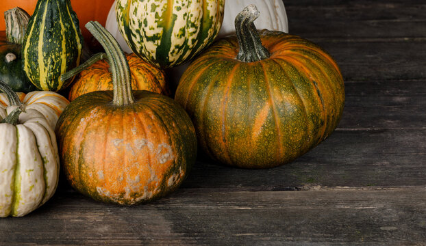 Flat lay arrangement with pumpkins on wooden background