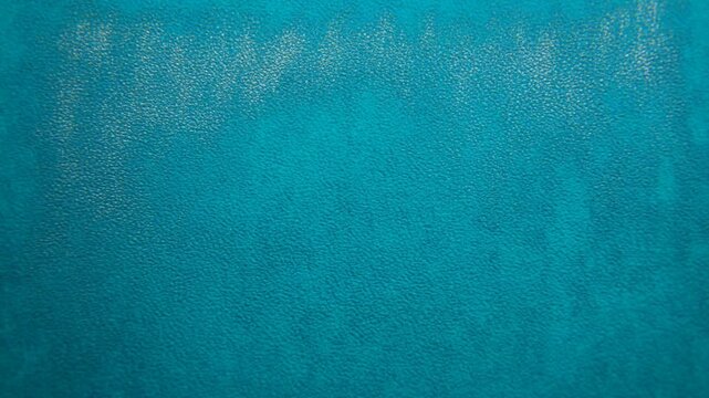 Abstract coppertoned surface with turquoise mottling and fine pebbled texture