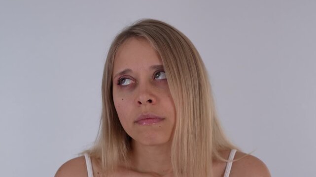 Young blonde woman showing a hiccup reaction, expressing sudden involuntary spasm, awkward interruption and mild discomfort
