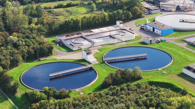 Aerial drone view of a water treatment plant facilities. Circular sedimentation tanks and filtration basins at a modern sewage facility.