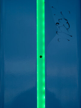 texture on the wall with blue plastic and green led stripe