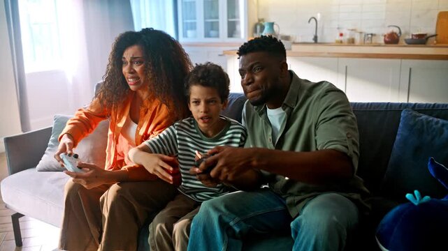 Family losing video game couch. Disappointed mother father son gamepad home.
