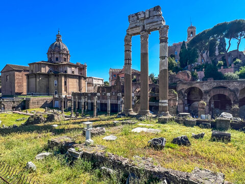 The Roman Forum in Rome, showing the Baroque dome of the church of Santi Luca e Martina in the center, along with the ruins of ancient temples (including columns)