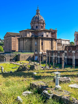 The Roman Forum in Rome, showing the Baroque dome of the church of Santi Luca e Martina in the center, along with the ruins of ancient temples (including columns)