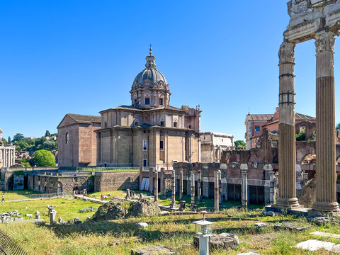 The Roman Forum in Rome, showing the Baroque dome of the church of Santi Luca e Martina in the center, along with the ruins of ancient temples 