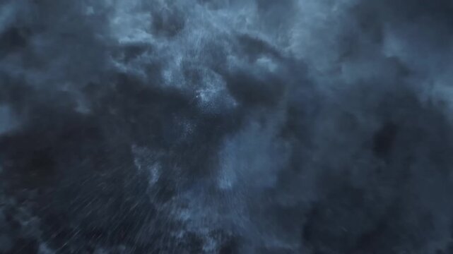 Heavy storm clouds fill the blue sky as faint rays of sunlight filter through