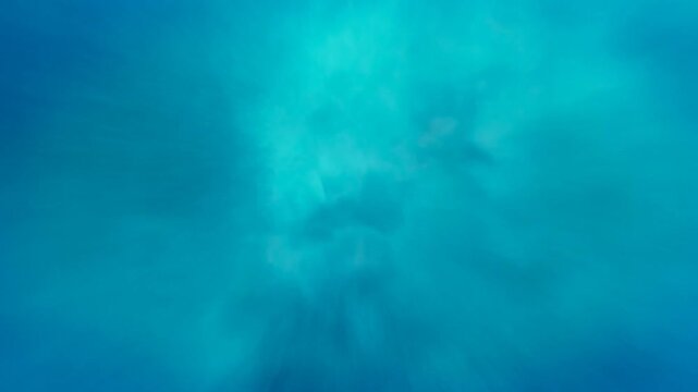 Sunlight rays diffuse through blue water in an abstract underwater scene