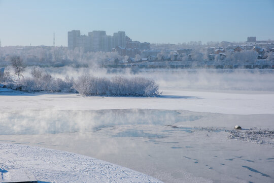 Misty morning blankets a frozen Angara riverbank