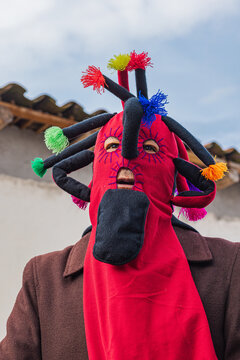 Portrait of man wearing traditional colorful Aya Huma mask during Andean festival in Ecuador
