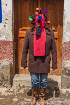Portrait of man wearing traditional colorful Aya Huma mask during Andean festival in Ecuador