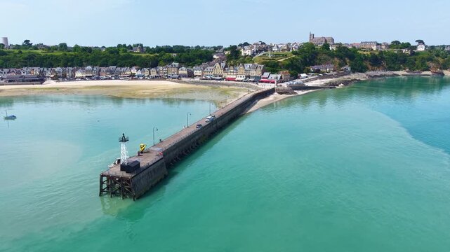 Aerial view of the picturesque fishing village of Cancale on the Emerald Coast. The picture shows the Port de la Houle harbour area at low tide with the distinctive Cale de l'&Eacute;pi pier. The row of ho