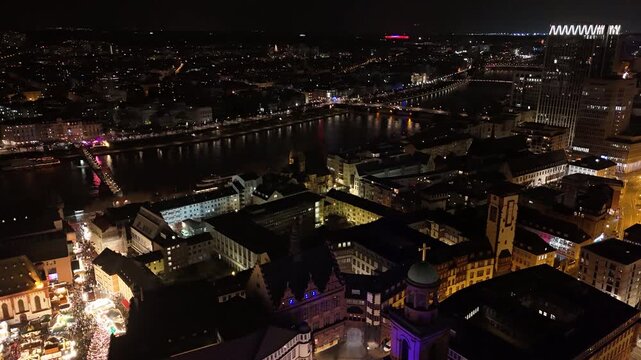 Aerial view of the illuminated Christmas market at Paulsplatz and the historic Paulskirche in the city center at night in Frankfurt am Main, Hessen, Germany.