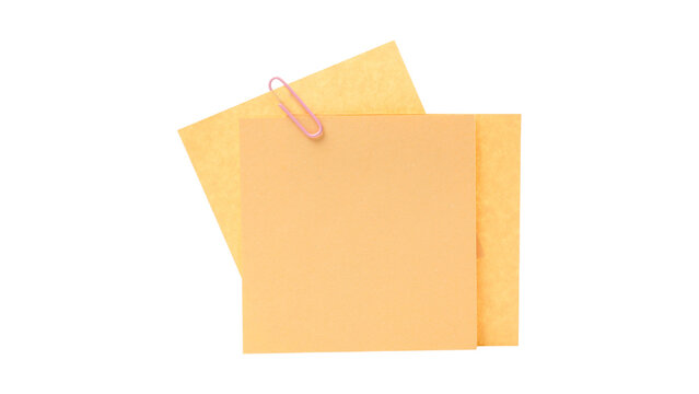 Two orange blank square sticky notes held together with a pink metal paper clip isolated on a white background