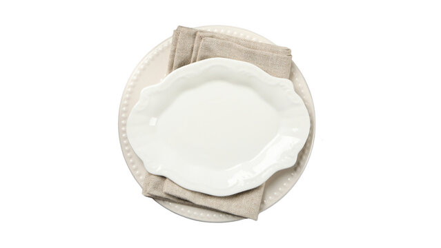 Top view of an elegant empty white oval ceramic plate with a decorative beaded charger and a beige linen napkin on a clean white background