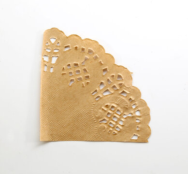 Quarter circle paper lace doily with intricate cutouts for vintage invitations and scrapbook projects.